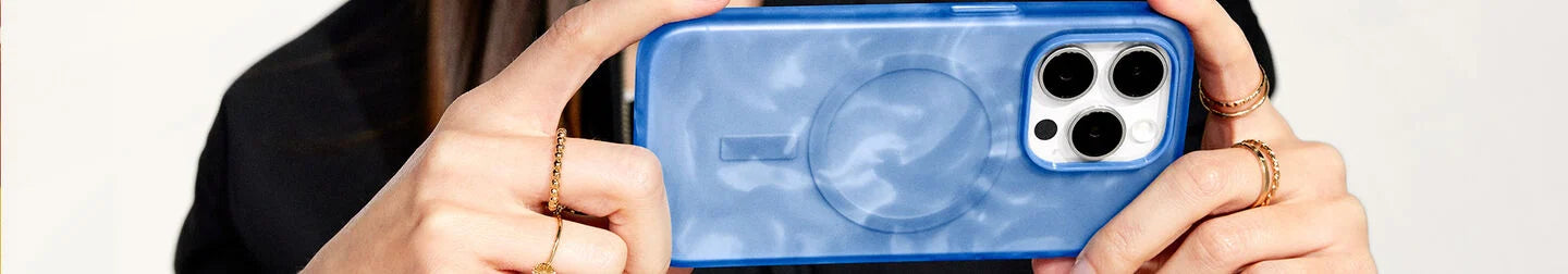 Woman taking a photo on iPhone 15 Pro Max in a blue and white swirled OtterBox Figura Series Artist Collection iPhone case