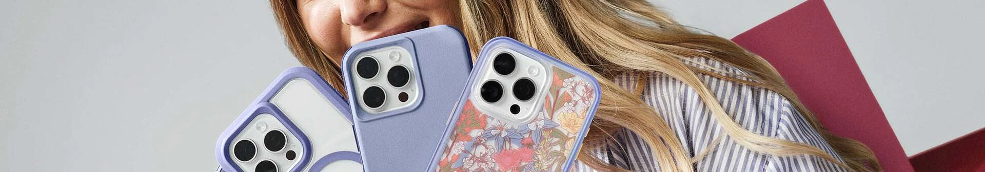 Woman holding a variety of trendy, stylish and pretty iPhone 16 Pro Max phones in OtterBox phone cases