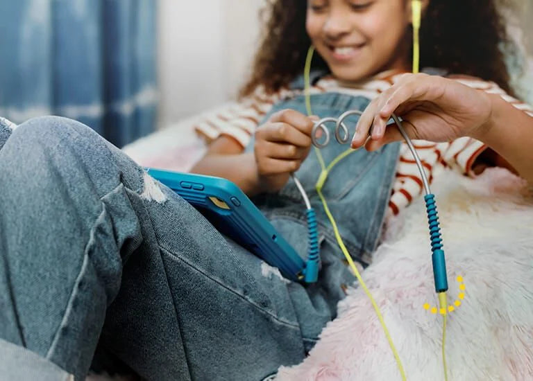 kid listening to music with easygrab mobile cable bundle