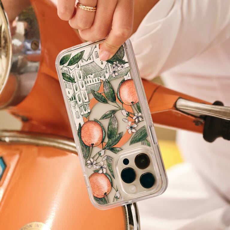 Phone case with floral design held by a person on a motorcycle