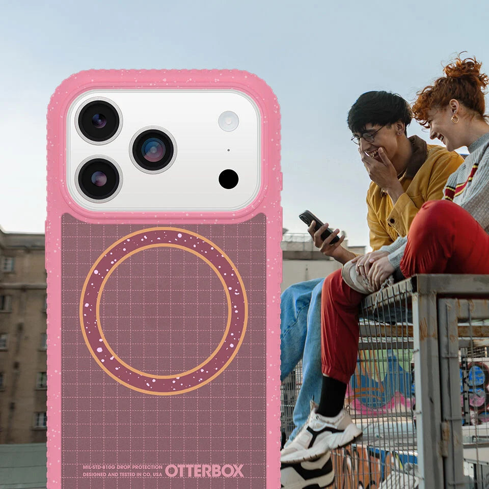 Pink OtterBox phone case with two people sitting on a railing in the background