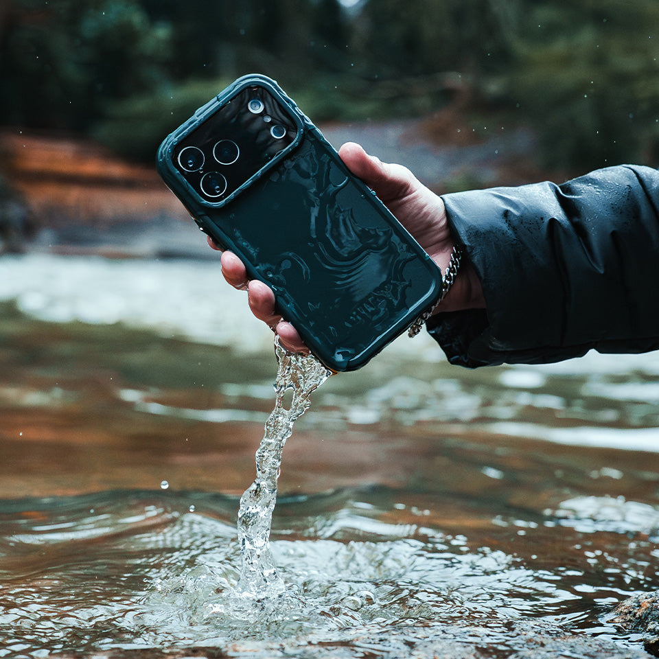 Person holding a phone with a waterproof case over a body of water