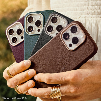 Four Cactus Leather iPhone cases in different colors held by a person with gold rings.