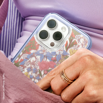 Person holding a phone with a floral case against a purple background