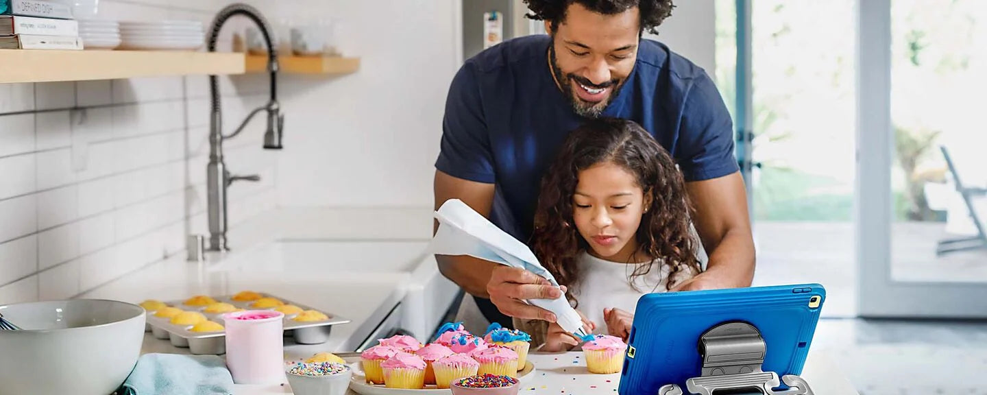 Dad and daughter watching cupcake tutorial on iPad with easygrab otterbox case