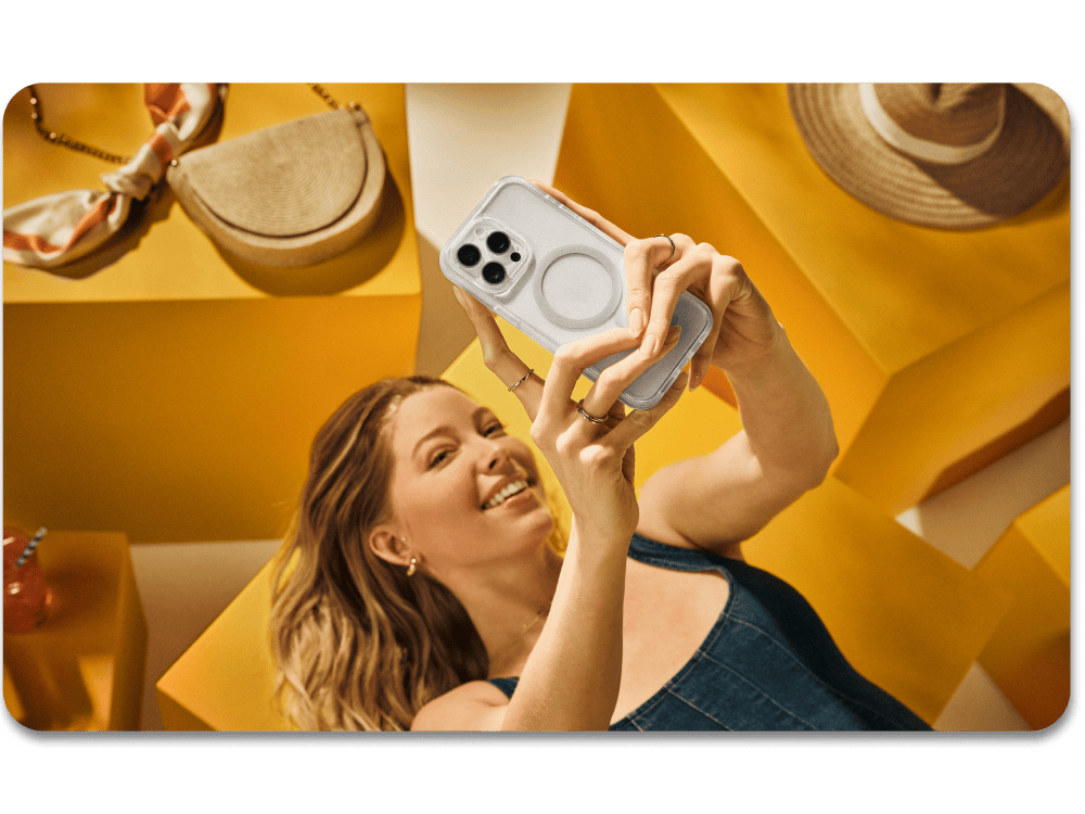 Woman taking a selfie with a phone in a yellow room