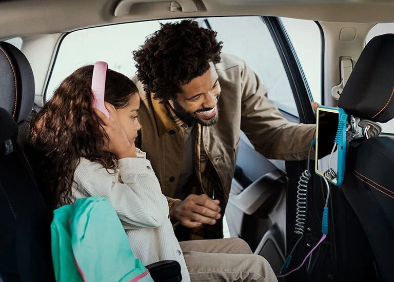 Man and child in a car using a smartphone with a car mount