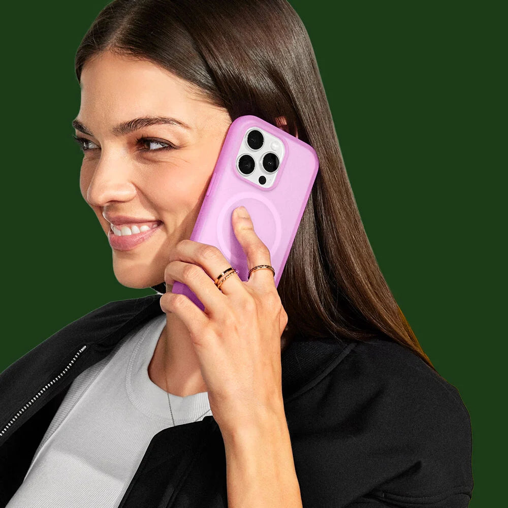 Woman holding a purple phone case against a green background